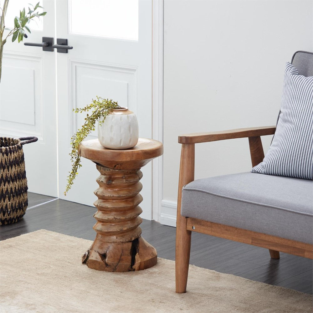 Wooden side table with vase near gray sofa and basket.