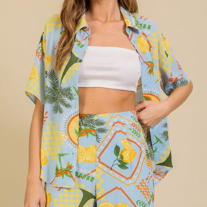 Colorful tropical outfit with fruit motifs and a white crop top.