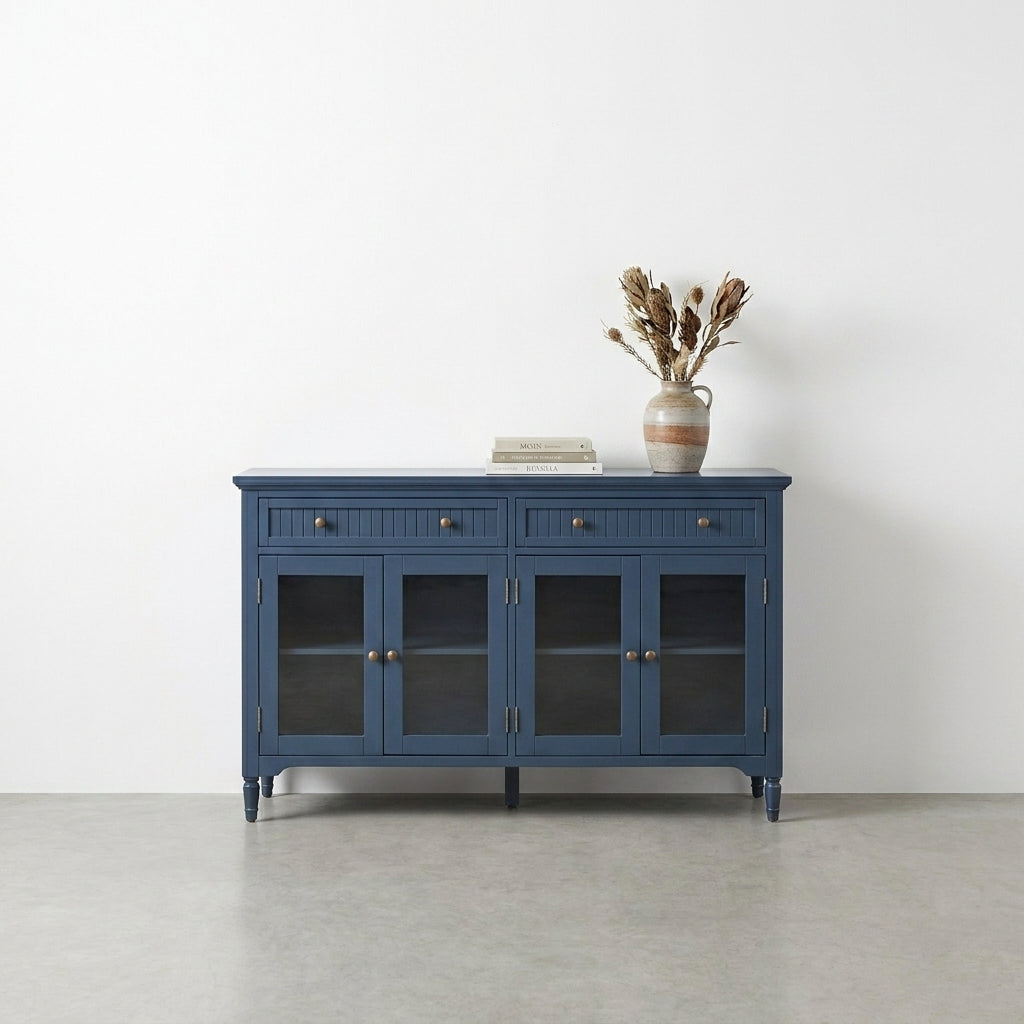 Blue cabinet with open glass doors and two drawers on top.