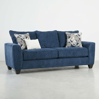 Blue sofa with three cushions on a light gray floor.