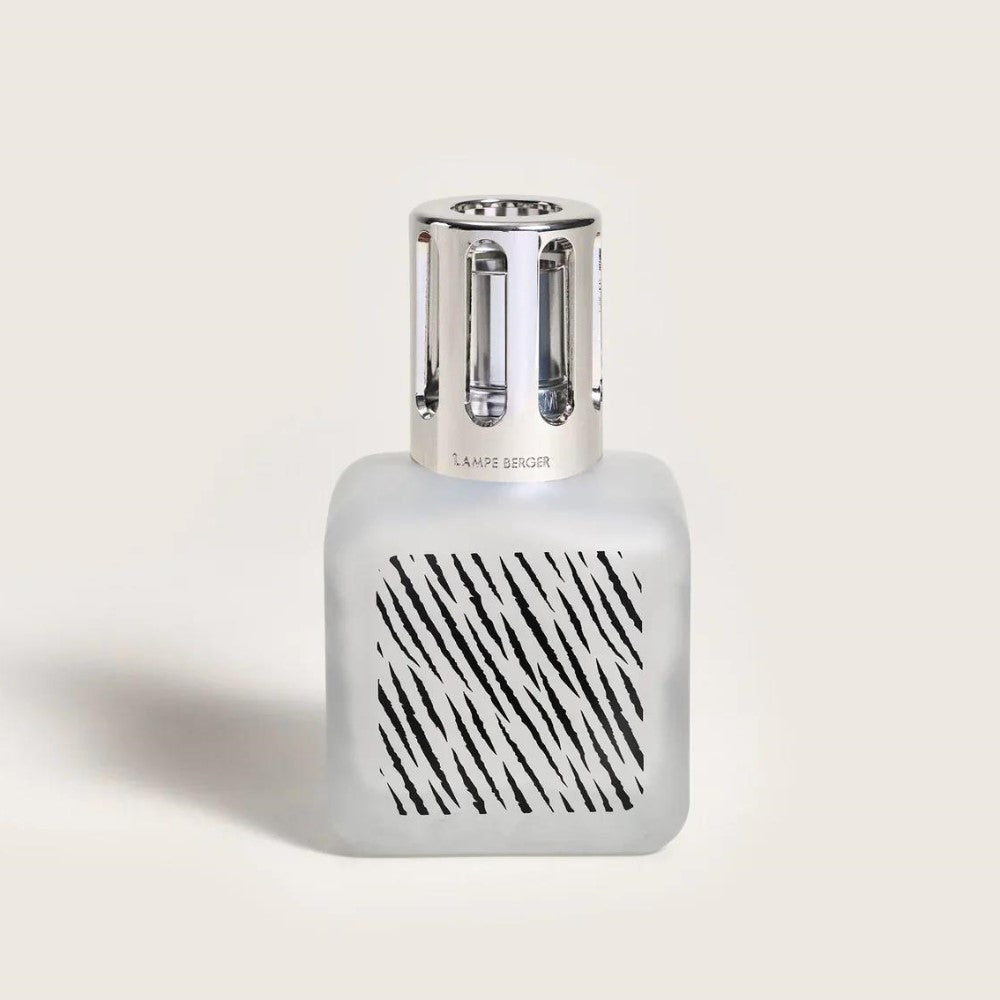 Frosted glass bottle with silver cap and striped pattern.