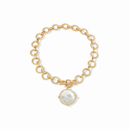 Gold link bracelet with round crystal charm.