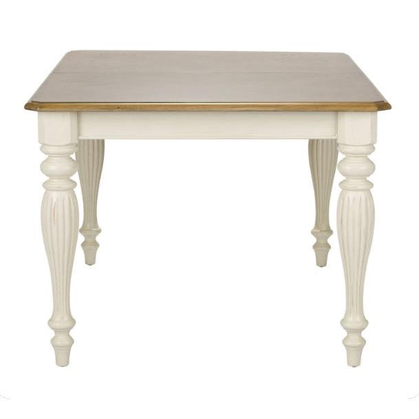 Elegant square table with carved white legs and wooden top.