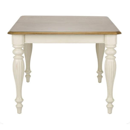 Elegant square table with carved white legs and wooden top.