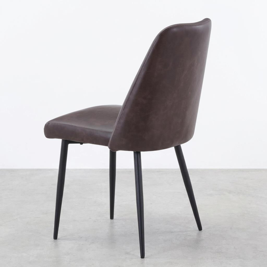 Brown leather chair with sleek black legs.