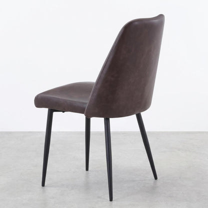 Brown leather chair with sleek black legs.