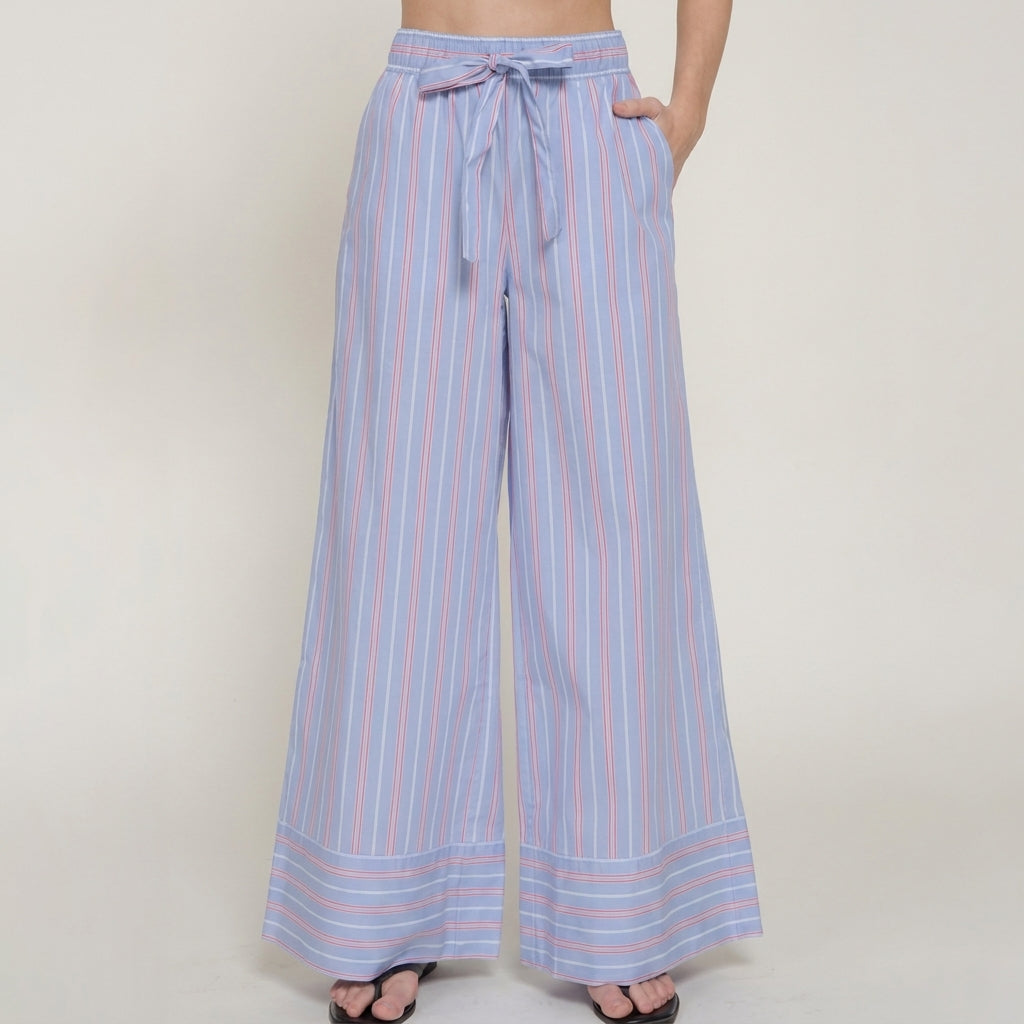 Blue striped wide-leg pants with a waist tie, worn with sandals.