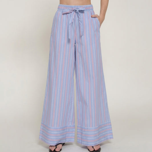 Blue striped wide-leg pants with a waist tie, worn with sandals.