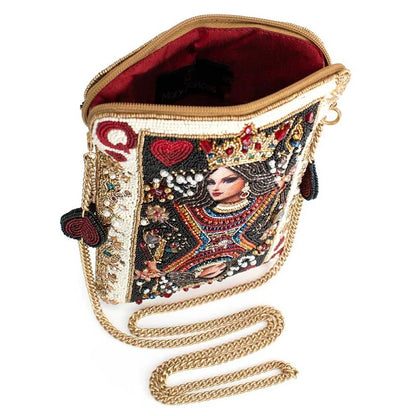 Embellished handbag with intricate beaded queen design and gold chain strap.