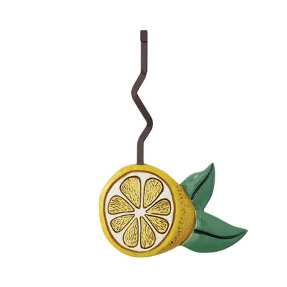 Lemon slice hanger with wavy hook and green leaves.