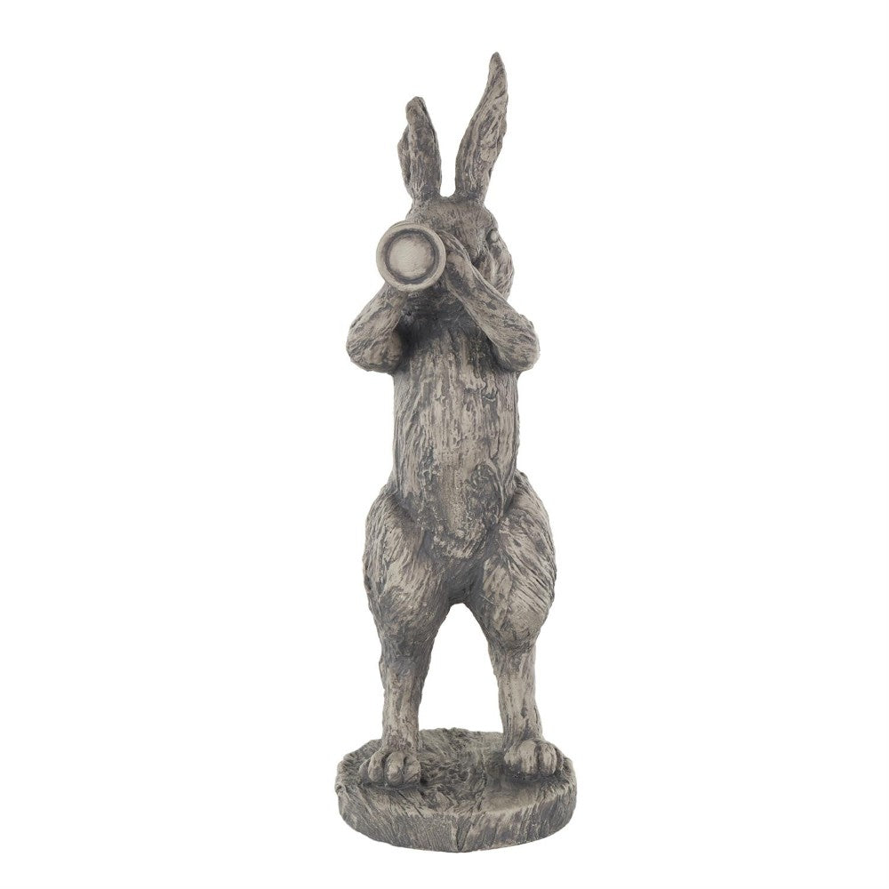 Rabbit sculpture with monocular on a stand.