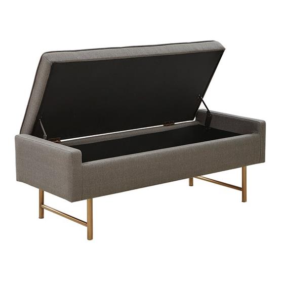 Gray bench with open storage and gold legs.