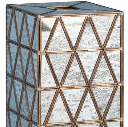 Geometric mirrored cube with triangular patterns in bronze frames.