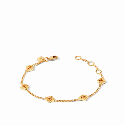A gold bracelet with delicate chain links and decorative clover-shaped charms on a white background.