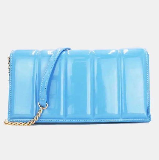 Glossy blue handbag with gold chain strap.