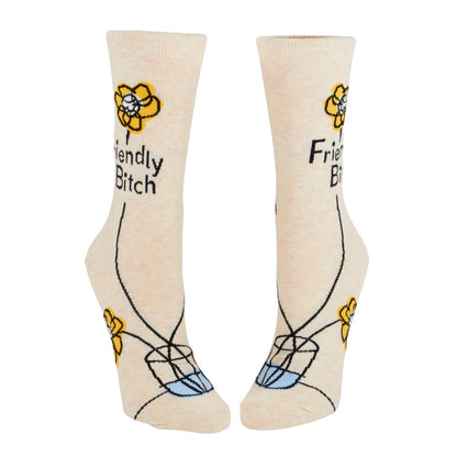 Beige socks with yellow flowers and playful "Friendly" text.