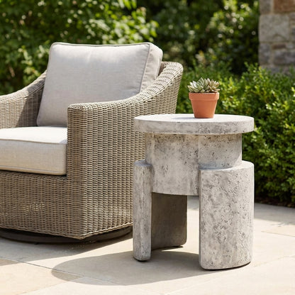 A textured concrete stool with a round top and curved legs.