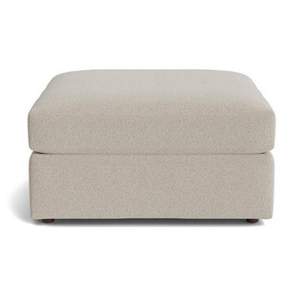 Beige rectangular ottoman with textured fabric.