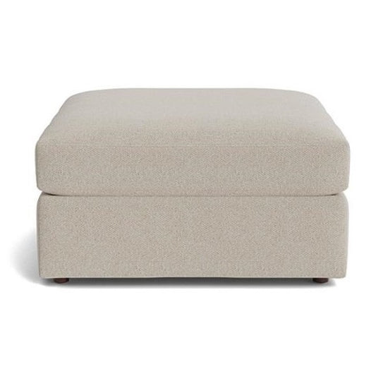 Beige rectangular ottoman with textured fabric.