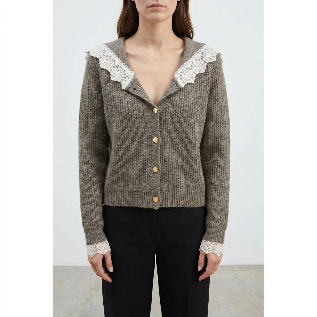 Woman in a brown cardigan with lace details and gold buttons.