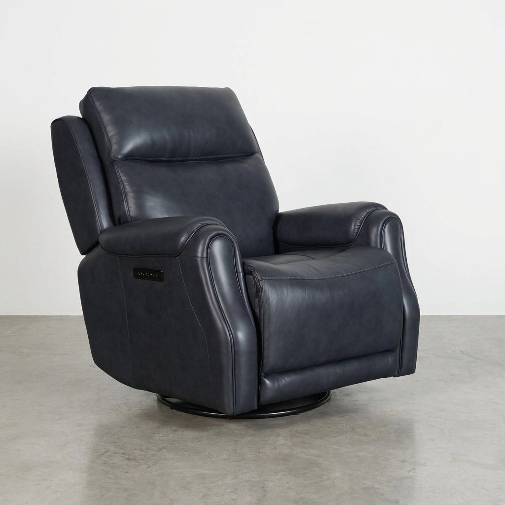 Black leather recliner chair on a concrete floor.