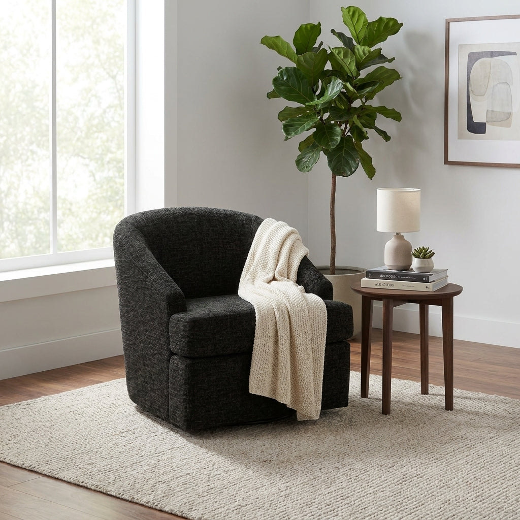 Cozy room with a black chair, side table, lamp, and plant by a window and artwork.