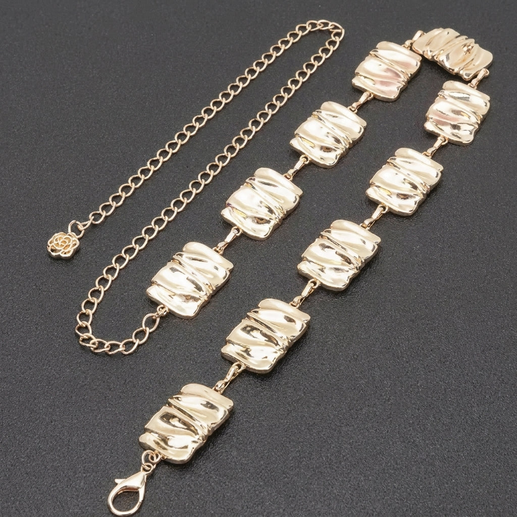Gold chain bracelet with textured square links on a dark background.