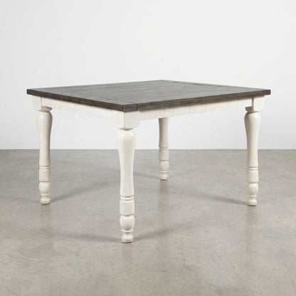 White wooden dining table with dark top.