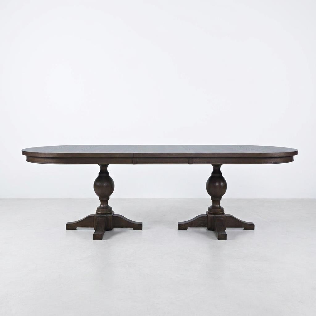 Dark wooden dining table with two pedestal legs.
