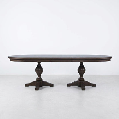 Dark wooden dining table with two pedestal legs.