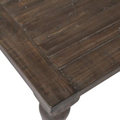 Close-up of a rustic wooden table corner with visible wood grain.