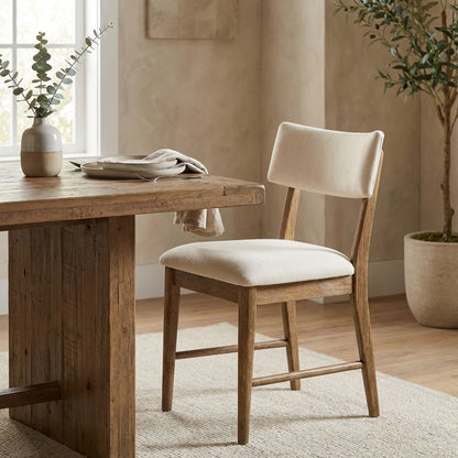 Wooden chair with beige cushioned seat and backrest.