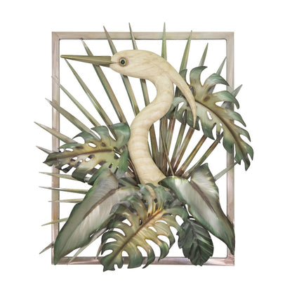 A crane sculpture among tropical leaves.