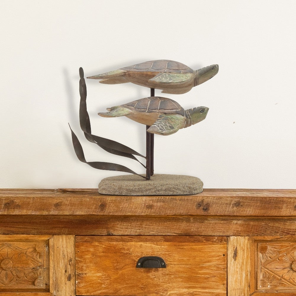 Two wooden turtle sculptures on a wooden dresser.