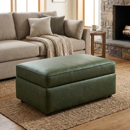 Cozy living room with a green ottoman and beige sofa by the fireplace.