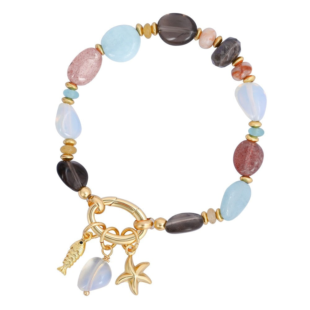 Colorful beaded bracelet with gold charms: fish, starfish, and gemstone.