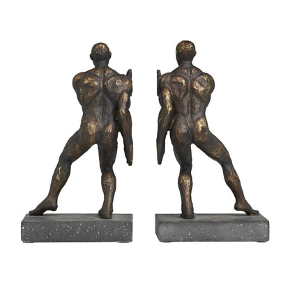 Two bronze male sculptures lean back on stone bases.
