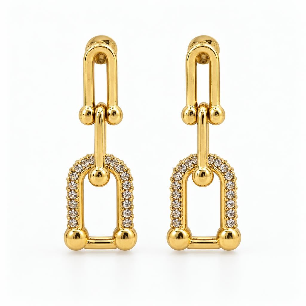 Pair of gold drop earrings with geometric links and sparkling stones.