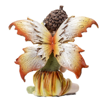 Seated fairy figurine with large orange and yellow wings.