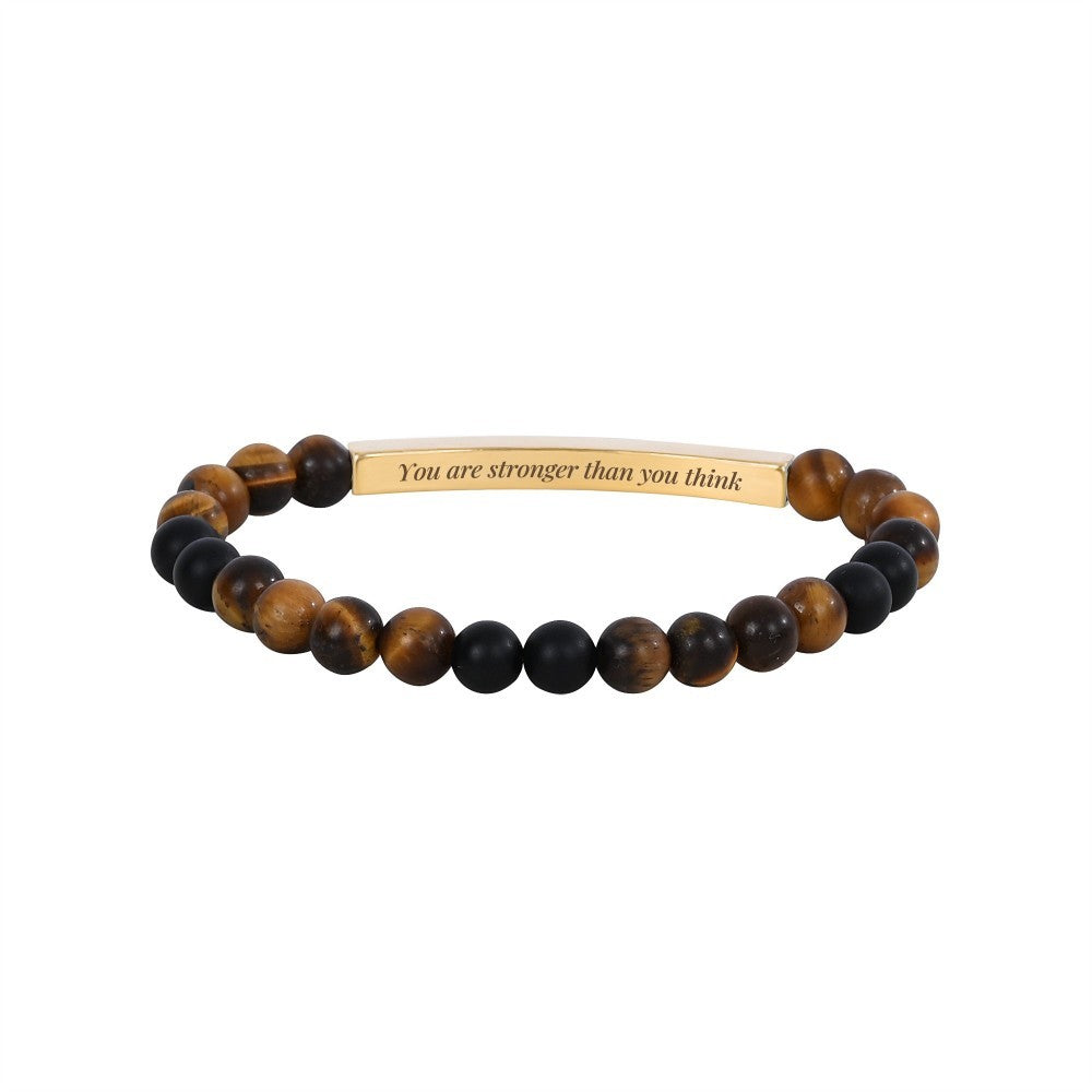 Beaded bracelet with a gold plate inscribed, "You are stronger than you think."