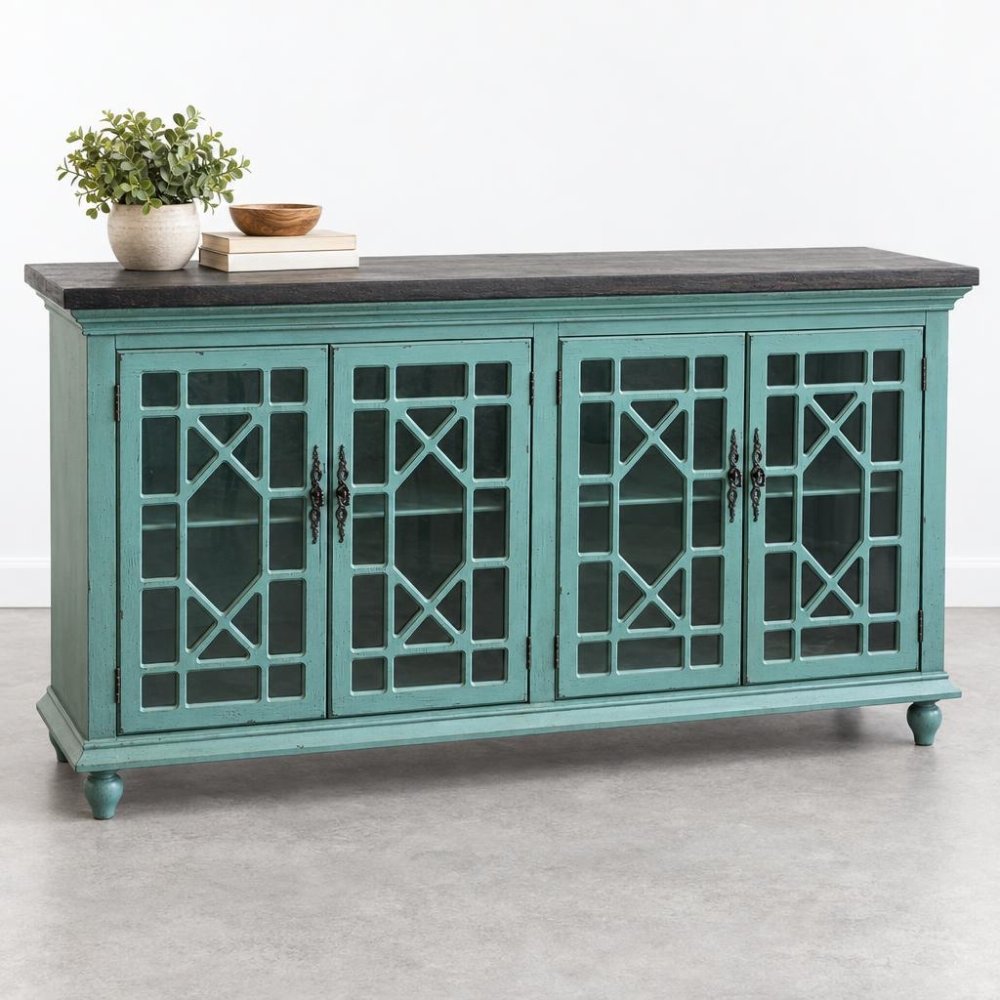 Teal wooden cabinet with lattice doors, books, and potted plant on top.