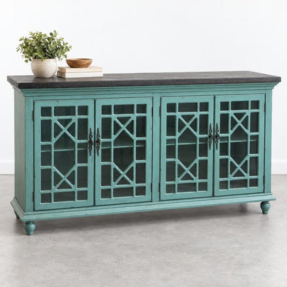 Teal wooden cabinet with lattice doors, books, and potted plant on top.