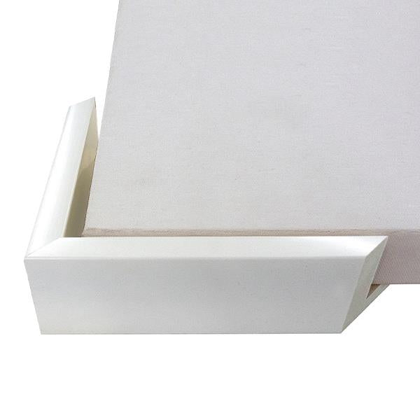 Close-up of a white photo frame corner with a canvas inside.