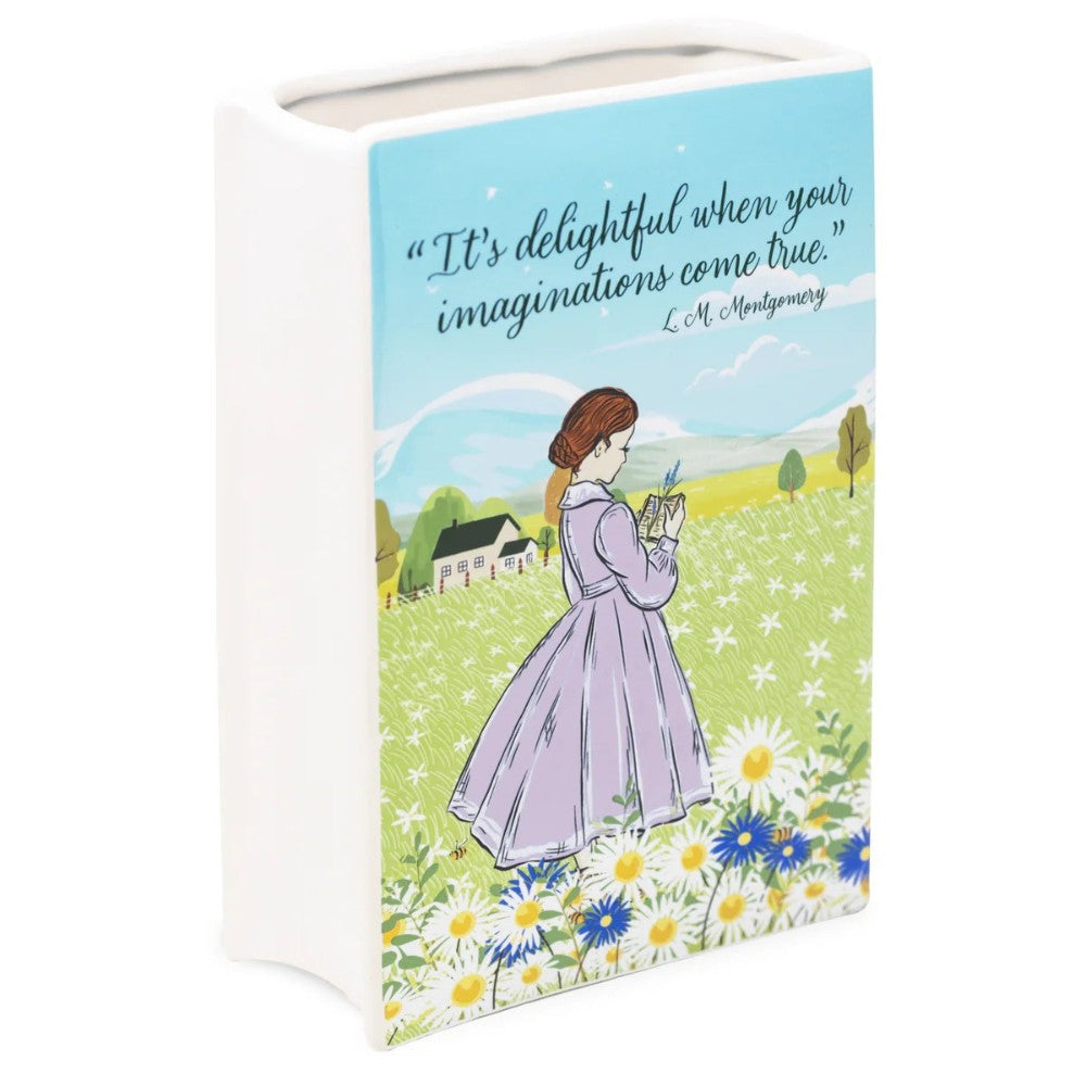 Woman in a field, reading, with L.M. Montgomery quote above.