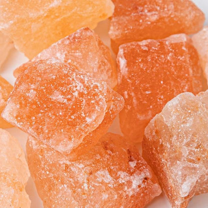 Close-up of orange and white rock sugar crystals.