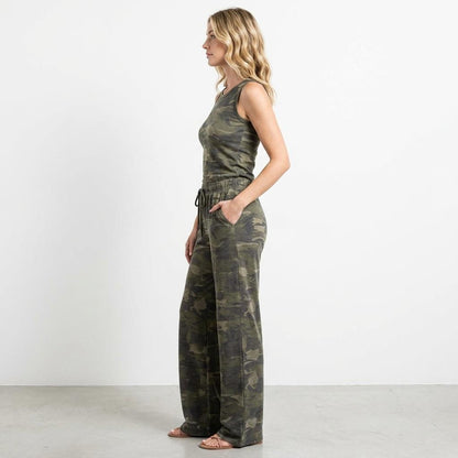 Person in camo outfit, standing sideways against a white background.