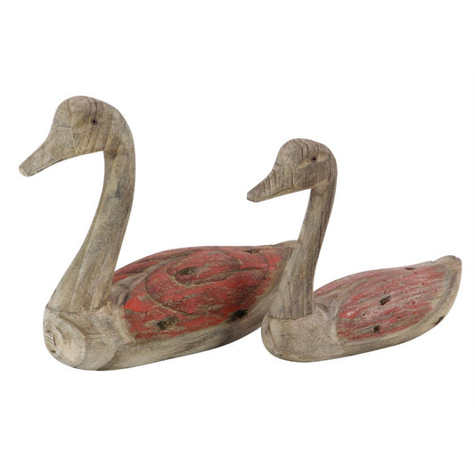 Two rustic wooden duck sculptures with red accents.