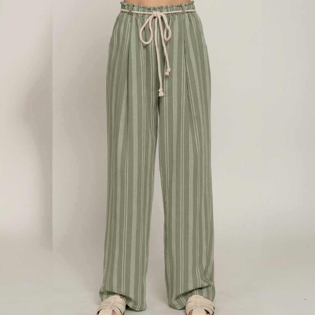 Green striped pants with a drawstring waist and white sandals.