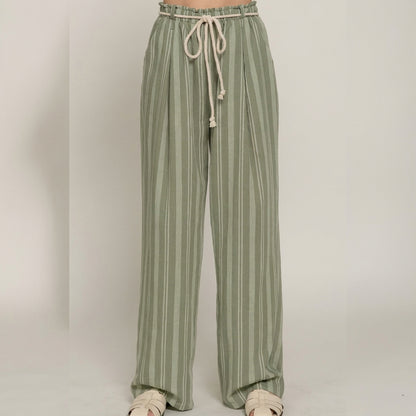 Green striped pants with a drawstring waist and white sandals.