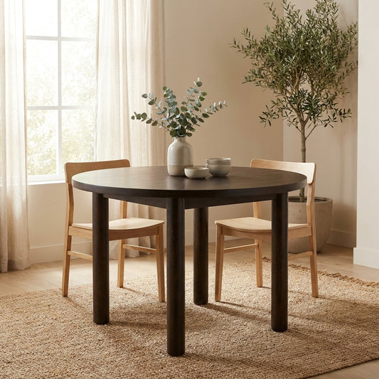 Round wooden table with four sturdy legs.